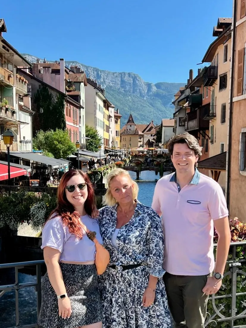 Anna and guests on a bridge in Annecy old town with the French Alps in the background